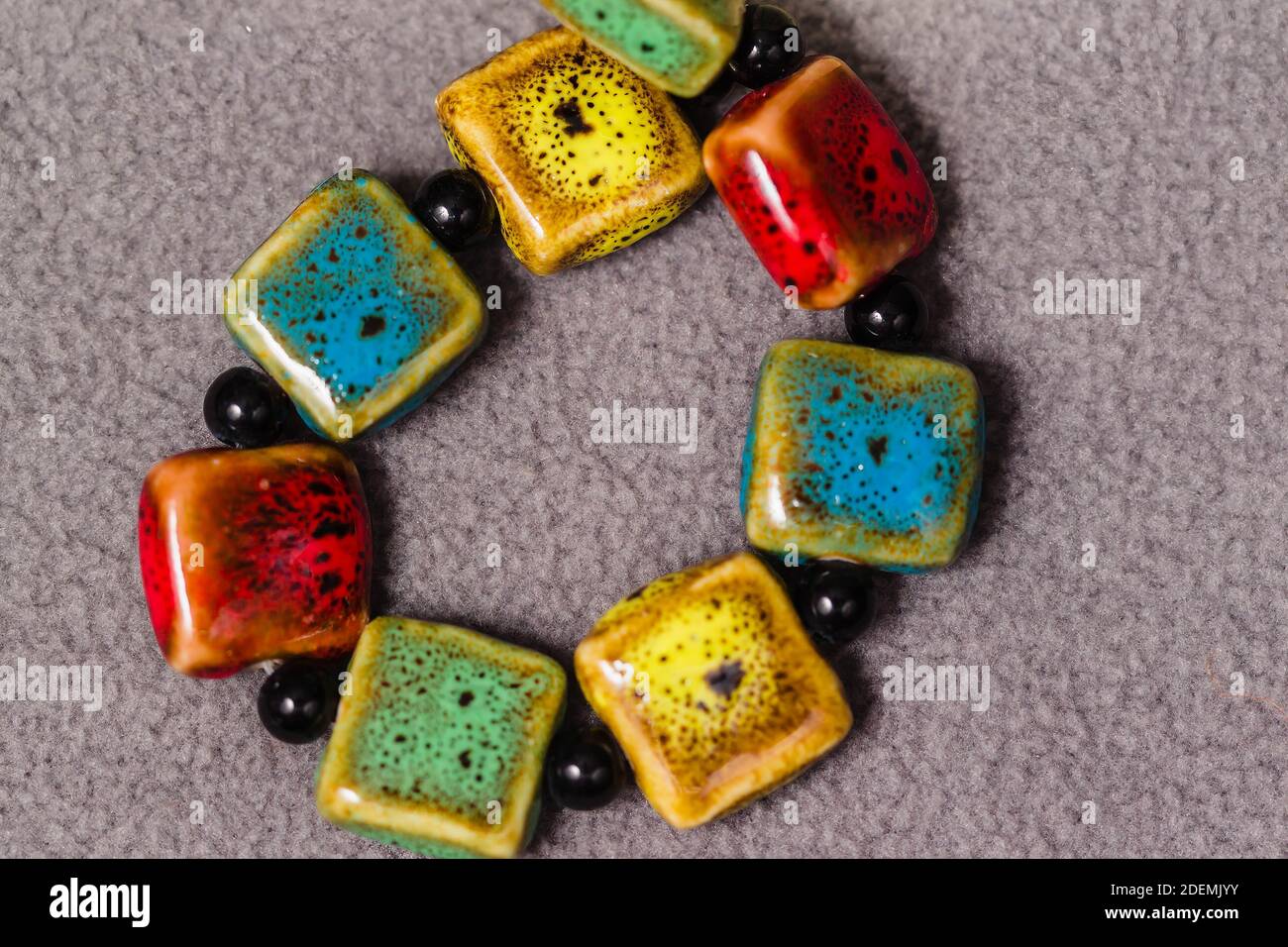 stand of square multi colored beads for the creation of jewelry Stock Photo