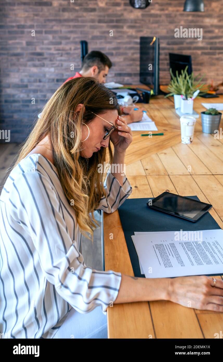 Worried businesswoman looking at a document in the office Stock Photo