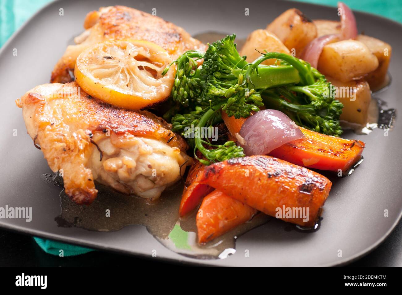 crispy chicken thighs with fingerling potatoes, carrots and green