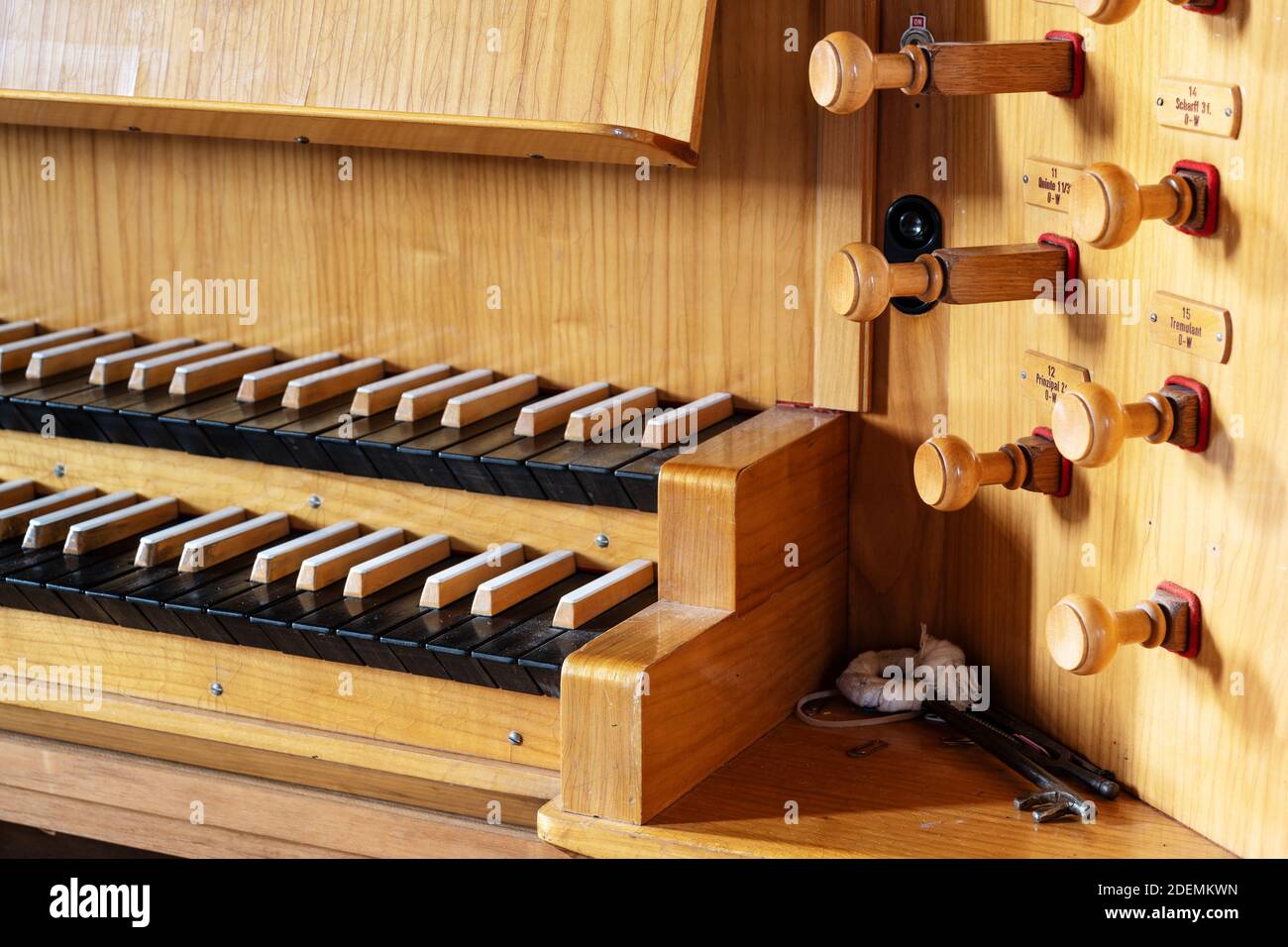 Part of a pipe organ console with two keyboards or manuals and wooden