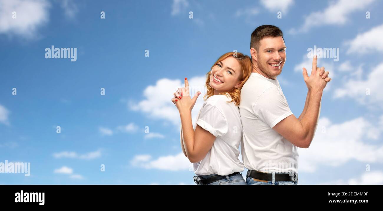 couple in white t-shirts shirts making gun gesture Stock Photo