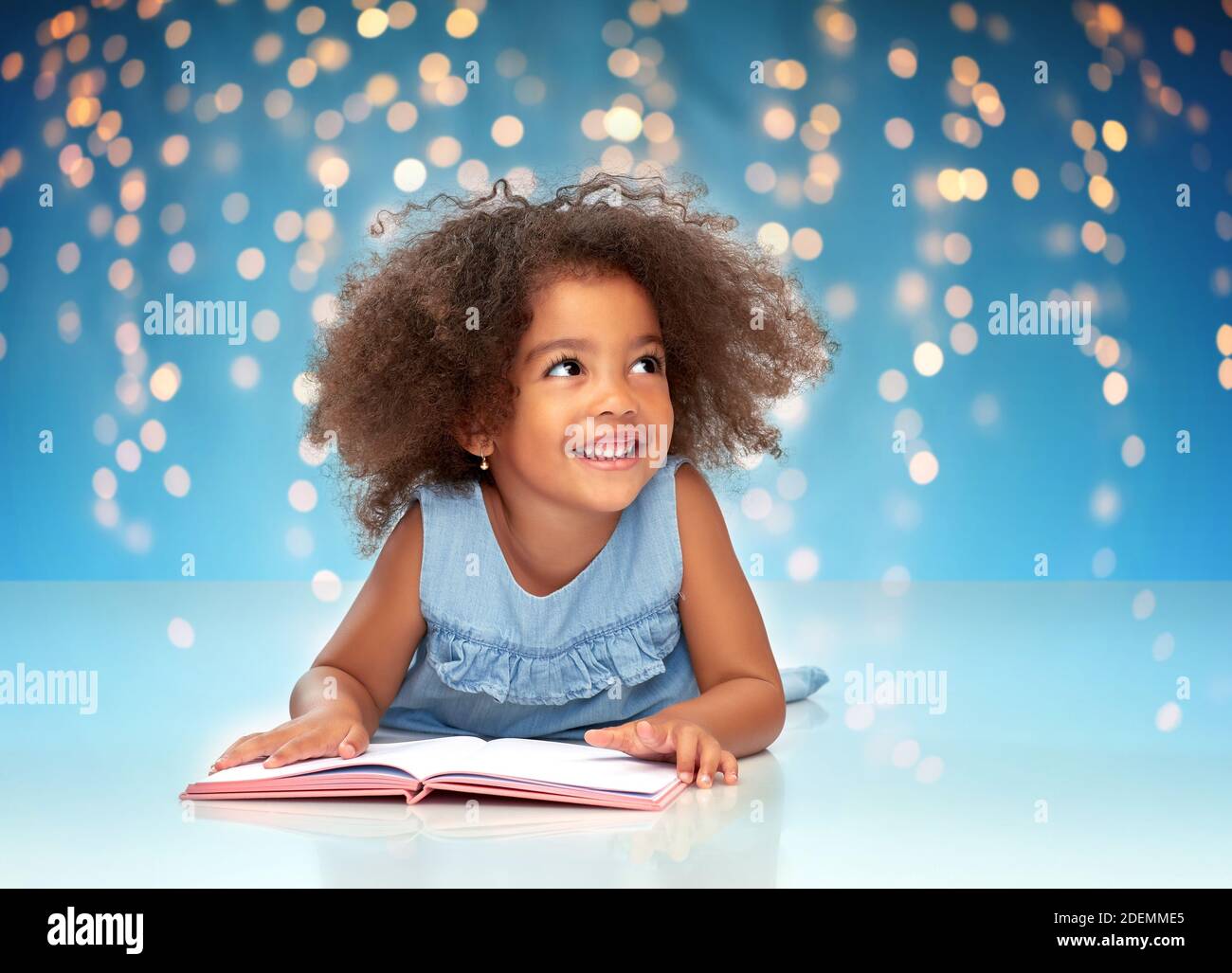 smiling little african american girl reading book Stock Photo - Alamy