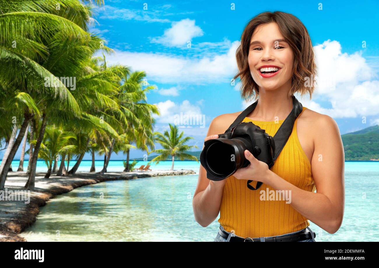 happy woman photographer with camera on beach Stock Photo - Alamy