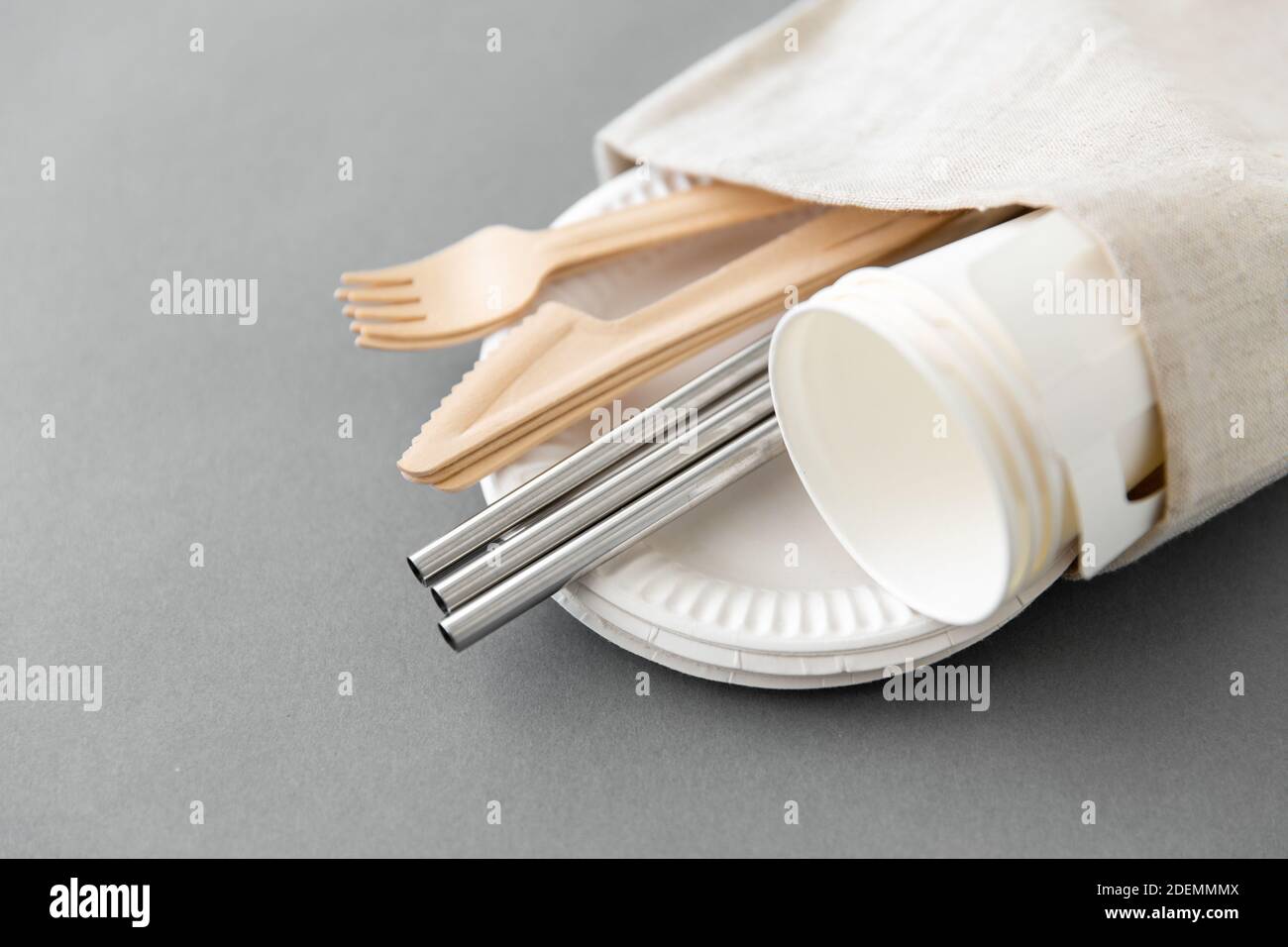 wooden forks, knives and paper cups on plate Stock Photo - Alamy