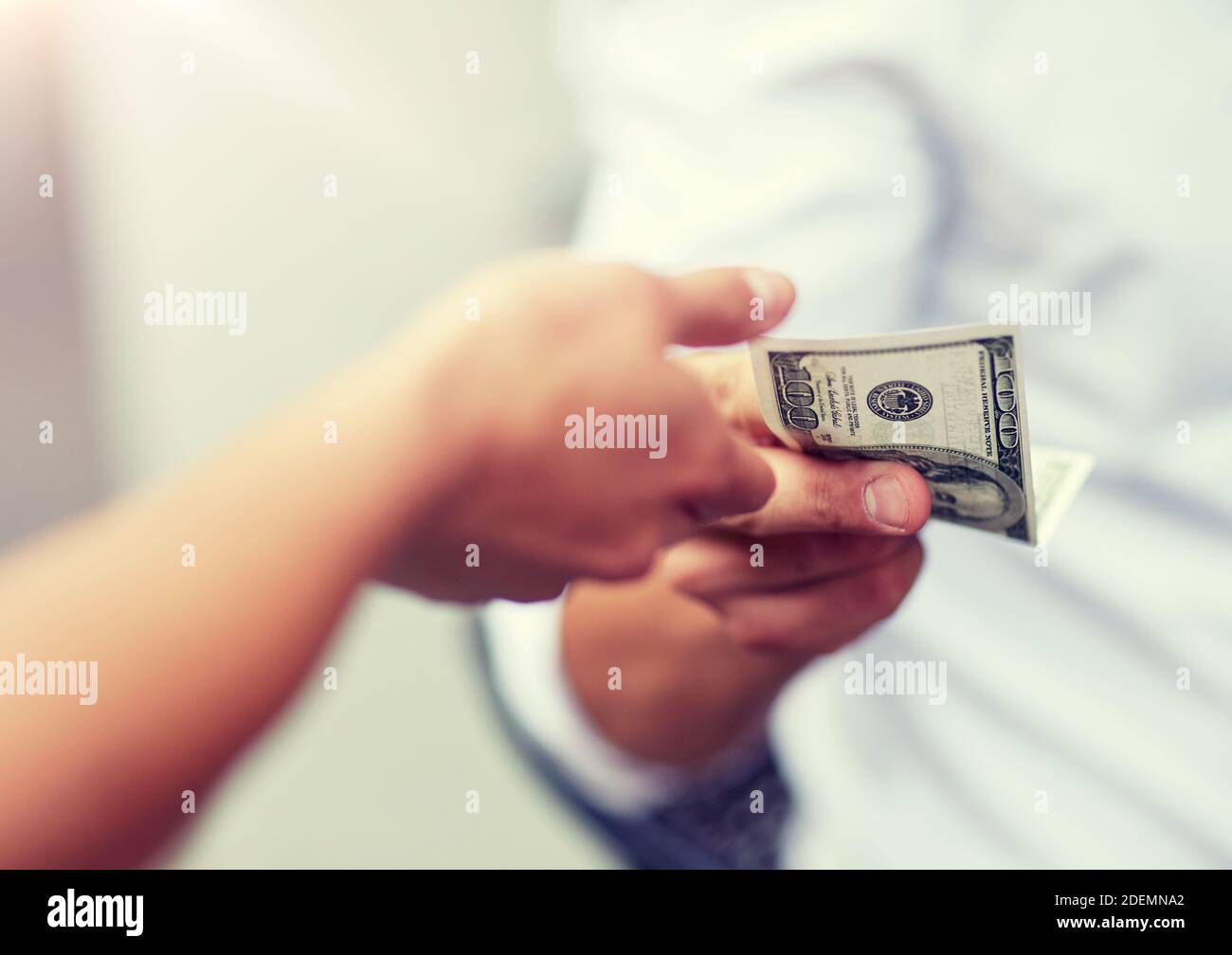 close up of hands giving and receiving dollar money Stock Photo