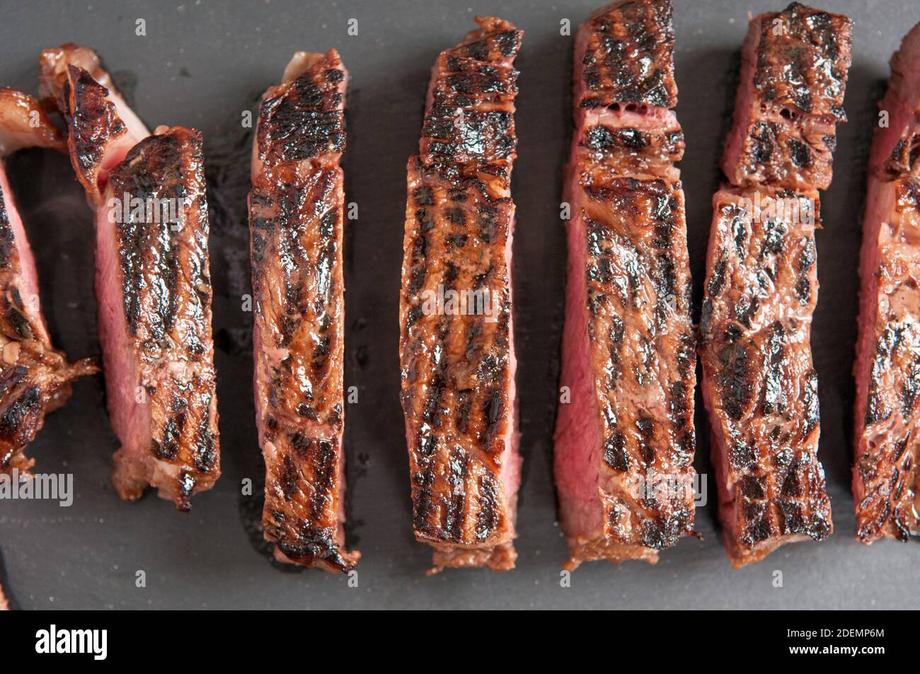 thick ribeye steak seared rare on a cast iron grill Stock Photo Alamy