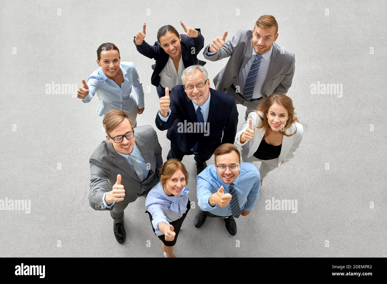 happy smiling business people showing thumbs up Stock Photo - Alamy