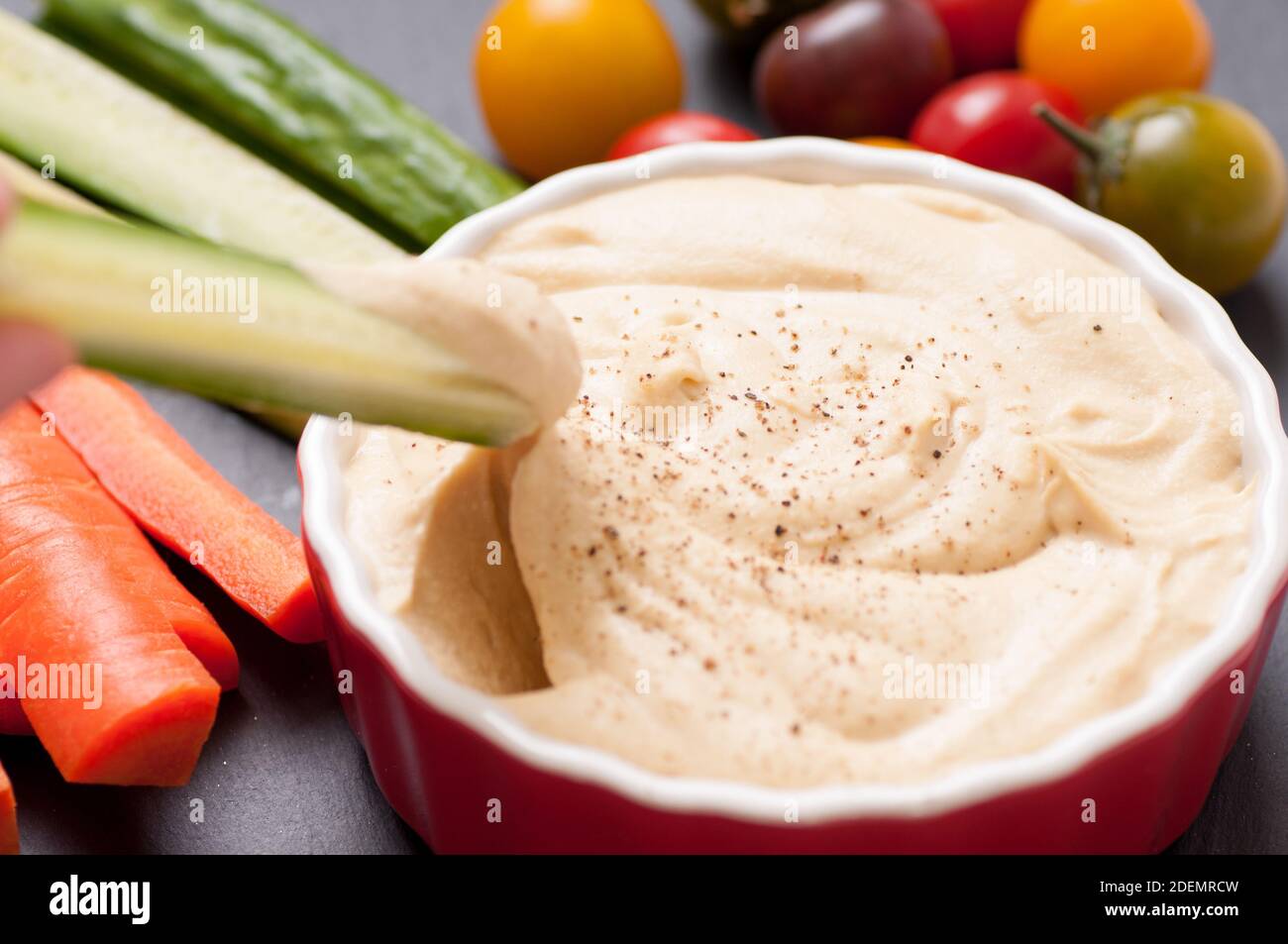 ground chickpea hummus with flatbreads and vegetables for dipping Stock Photo