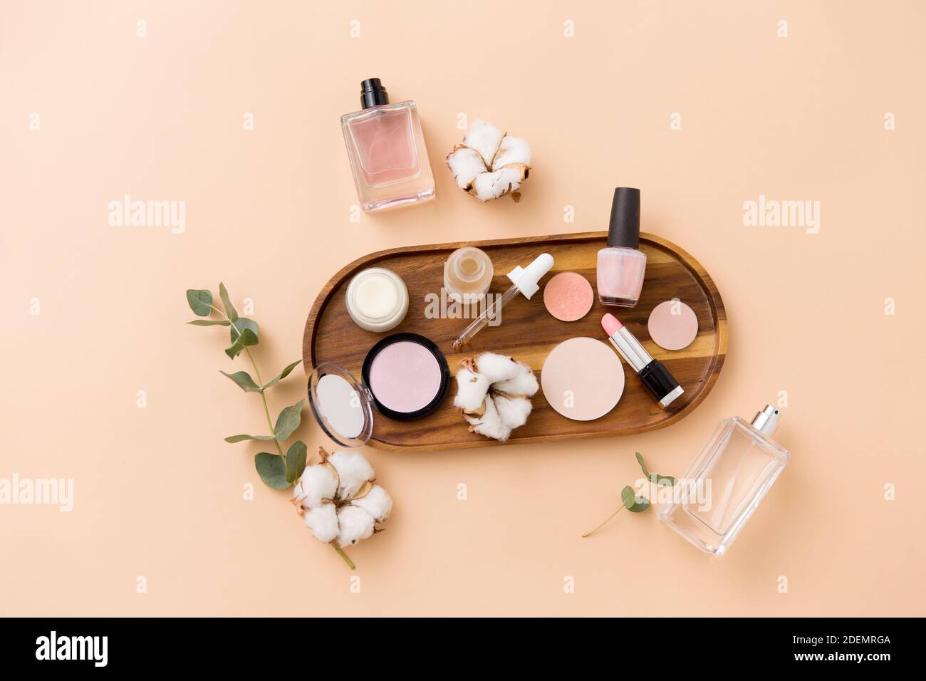 makeup, perfume and cosmetics on wooden tray Stock Photo