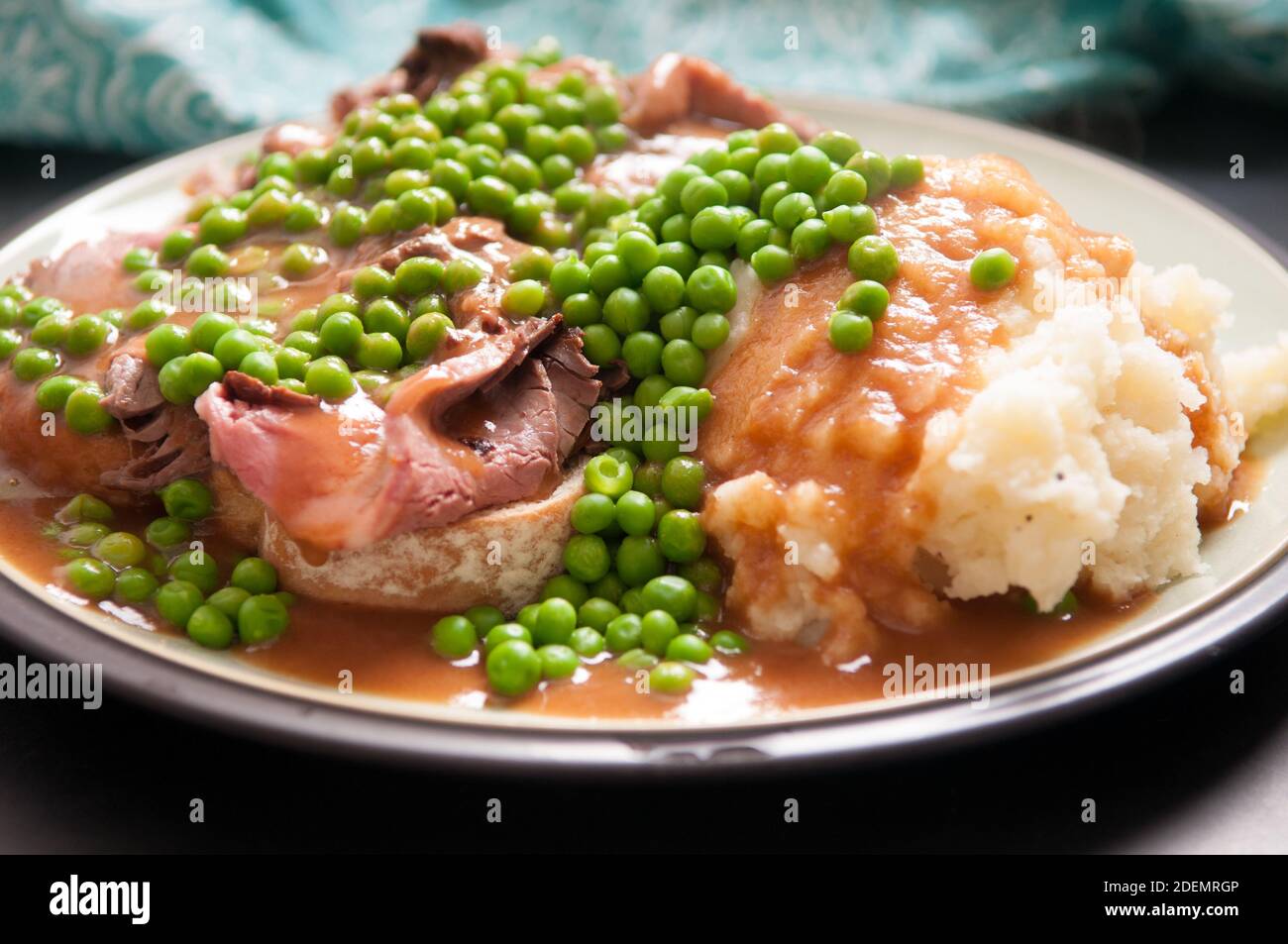 open faced hot roast beef sandwich with mashed and gravy and peas Stock Photo Alamy