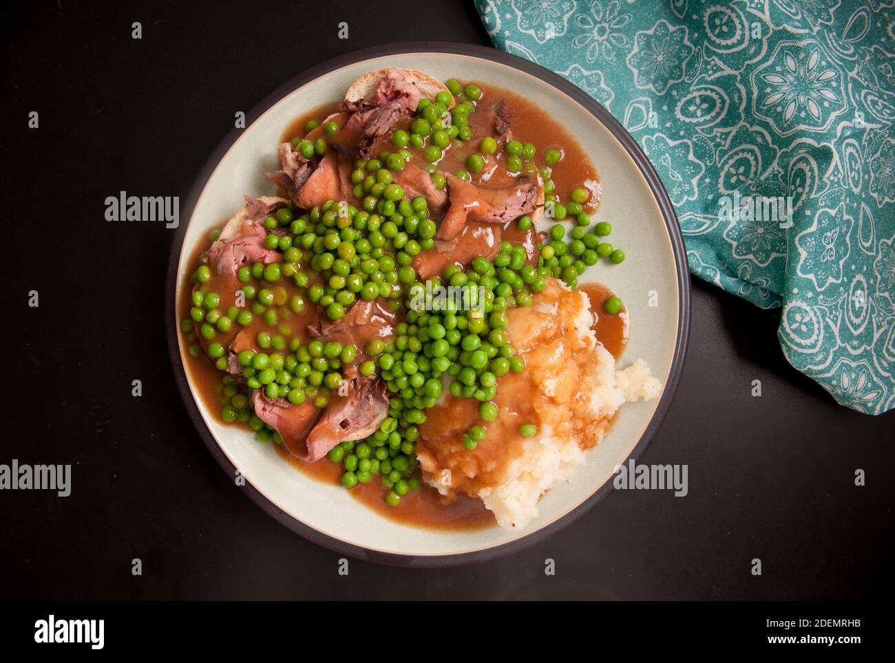 open faced hot roast beef sandwich with mashed and gravy and peas Stock