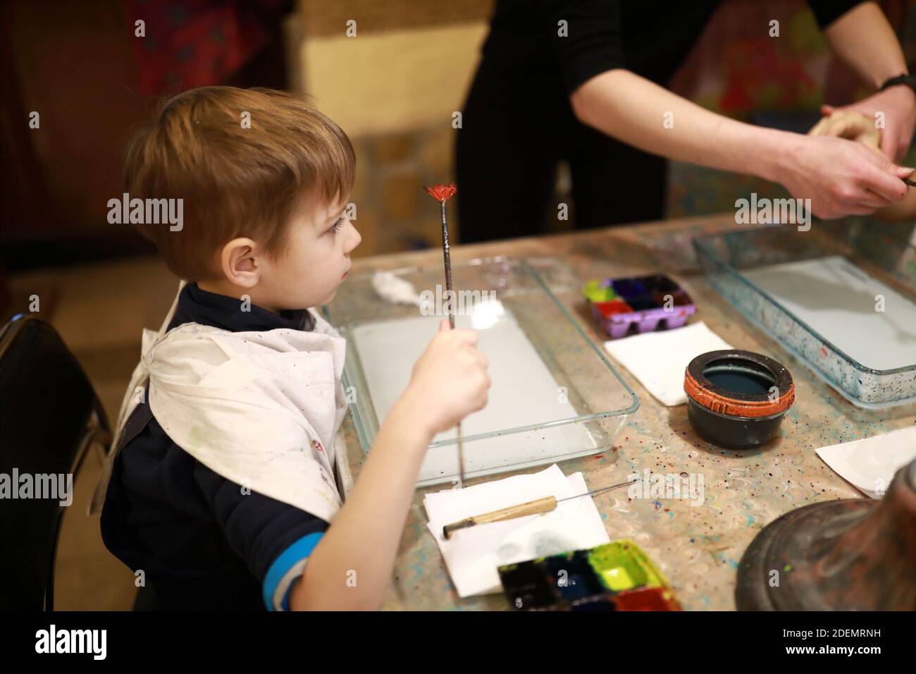 Child draws using ebru technique in workshop Stock Photo