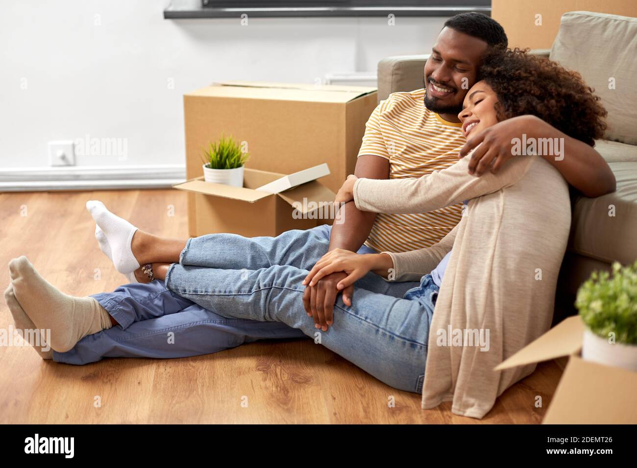 happy couple with boxes moving to new home Stock Photo - Alamy