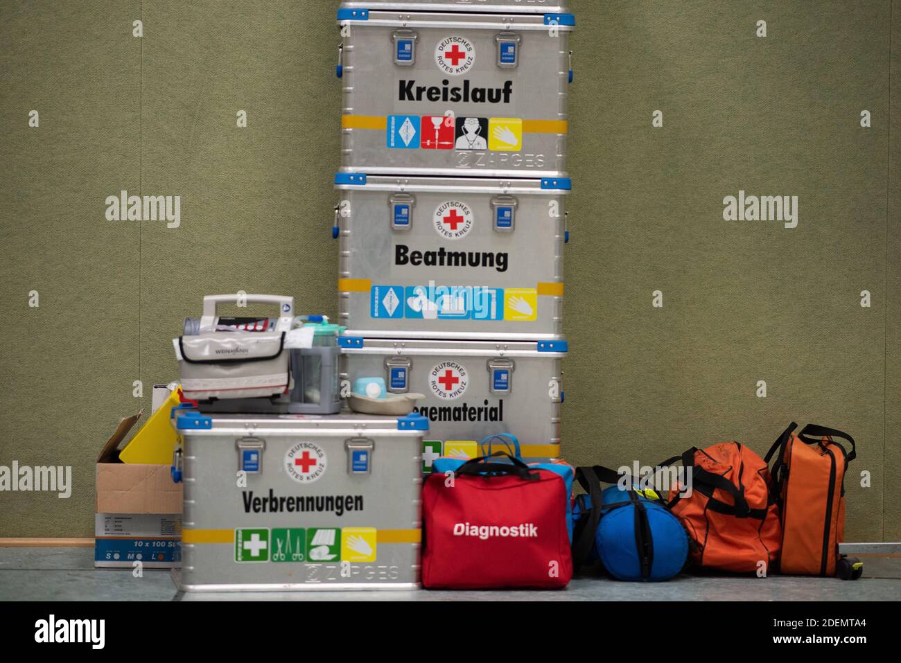 01 December 2020, Hessen, Eschwege: Various boxes of the German Red Cross are standing in the gymnasium of the upper school during the construction of a vaccination centre. In Eschwege in the Werra-Meissner district, a vaccination centre is being set up by the district and various disaster control organisations. Photo: Swen Pförtner/dpa Stock Photo