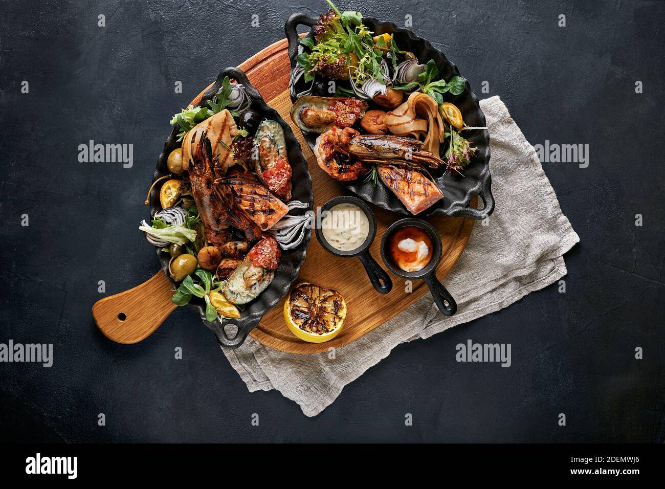 Mixed Roasted Seafood Platter Set, Contain Grilled Big Shrimps, Calamari  Squids and Barracuda Fish Garlic Pepper with Spicy Chili Sauce and Potatoes  Stock Photo - Alamy