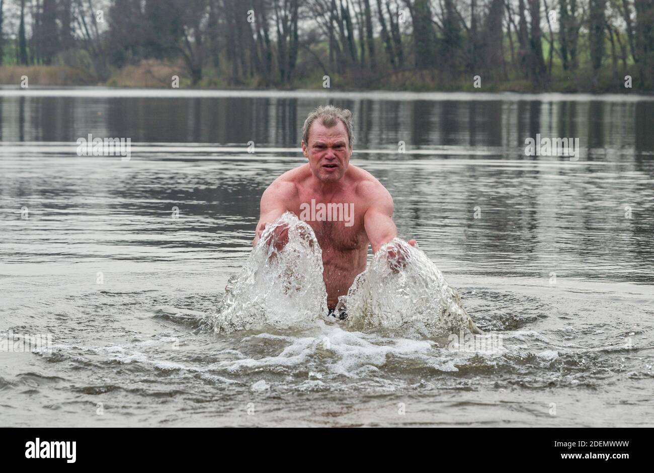 01 December 2020, Brandenburg, Alt Zeschdorf: The 66-year-old Klaus from Frankfurt (Oder) comes from the water of the Hohenjesarscher Lake, after a bath in water that is only four degrees Celsius cold. Klaus comes about twice a week from Frankfurt (Oder), 15 kilometres away, to pursue his passion for ice bathing. This keeps him young and healthy, he says. Photo: Patrick Pleul/dpa-Zentralbild/ZB Stock Photo