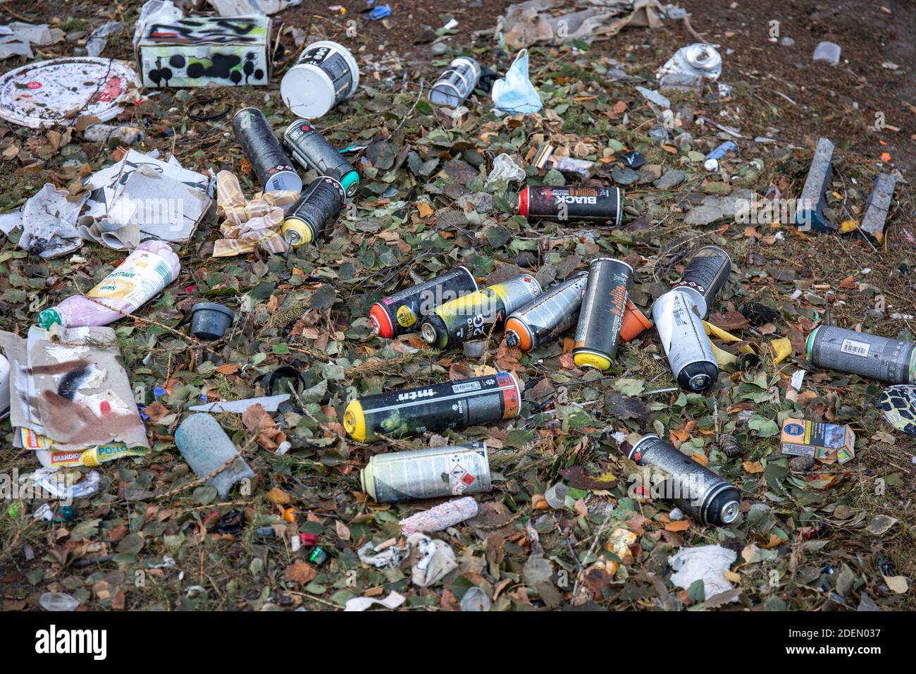 Empty used spray paint cans thrown off to the ground Stock Photo
