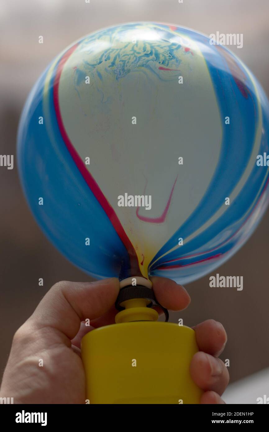 Blowing up balloon with the plastic pump Stock Photo Alamy