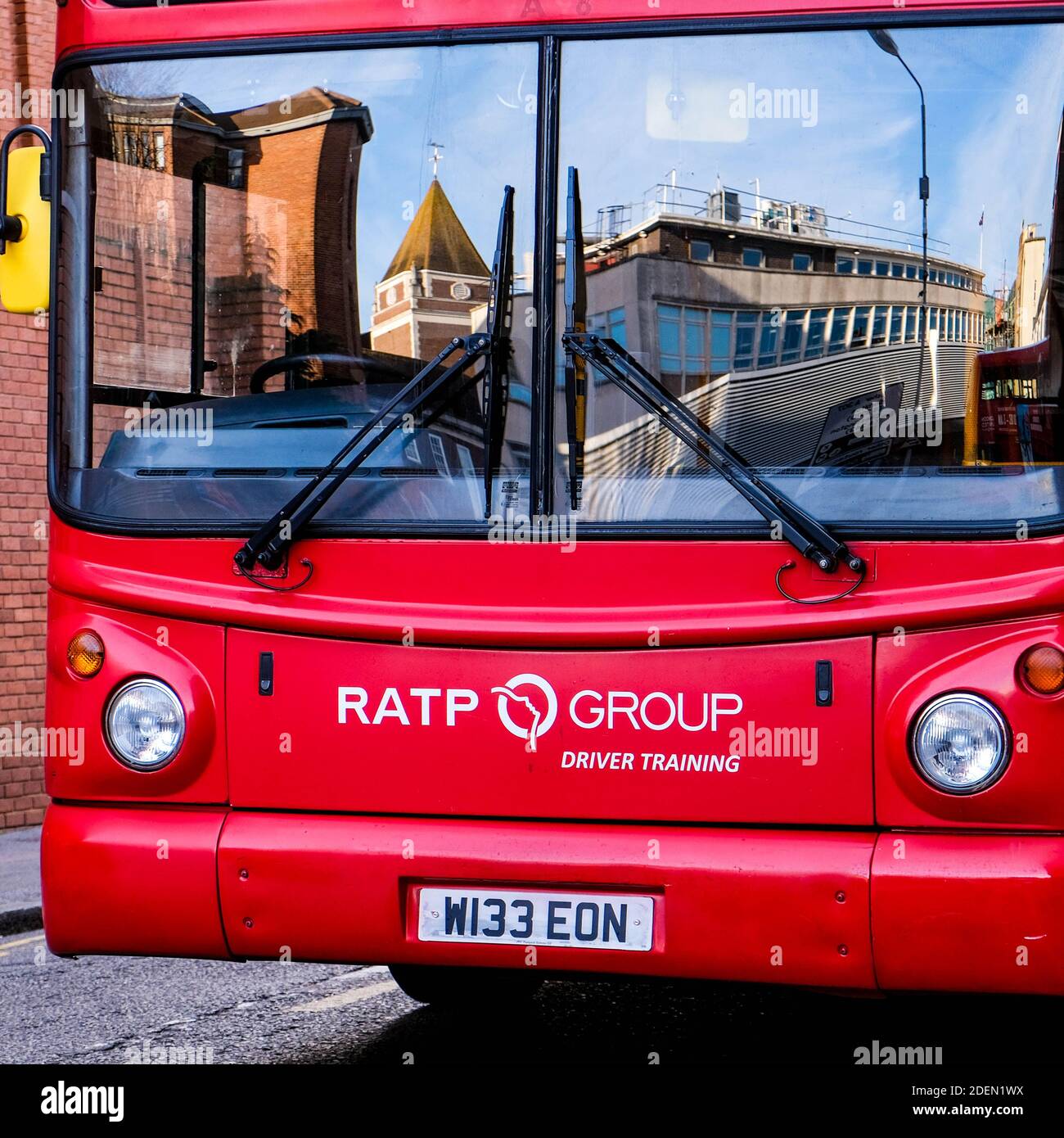 London UK, December 01 2020, Close Up Of A Red Double Decker Bus Parked Used For Driver Training With Reflections Of The City In It’s Front Window Stock Photo