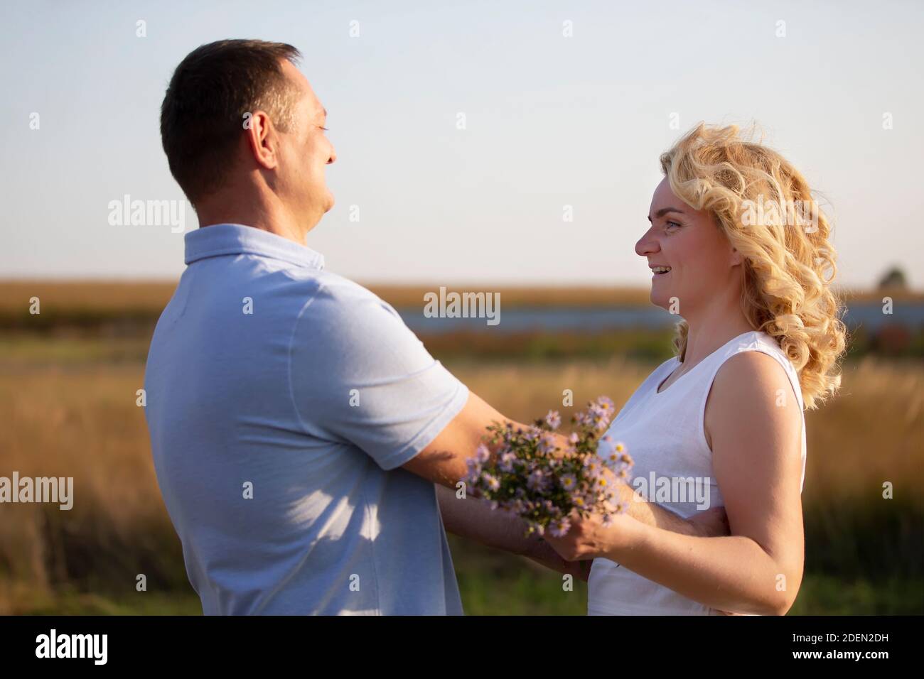 Beautiful middle-aged couple in love on the background of nature. Husband and wife. Stock Photo