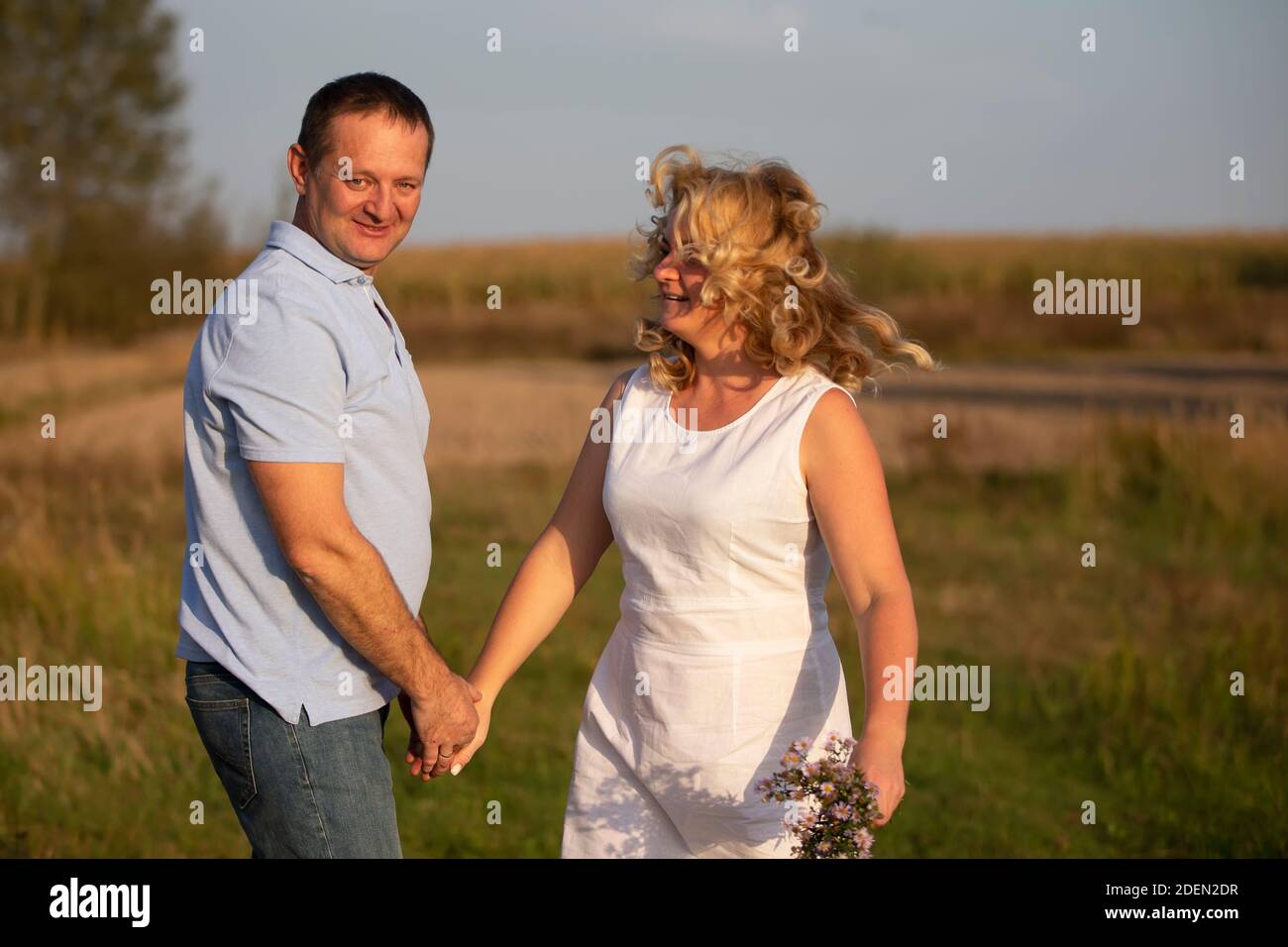 Beautiful middle-aged couple in love on the background of nature. Stock Photo