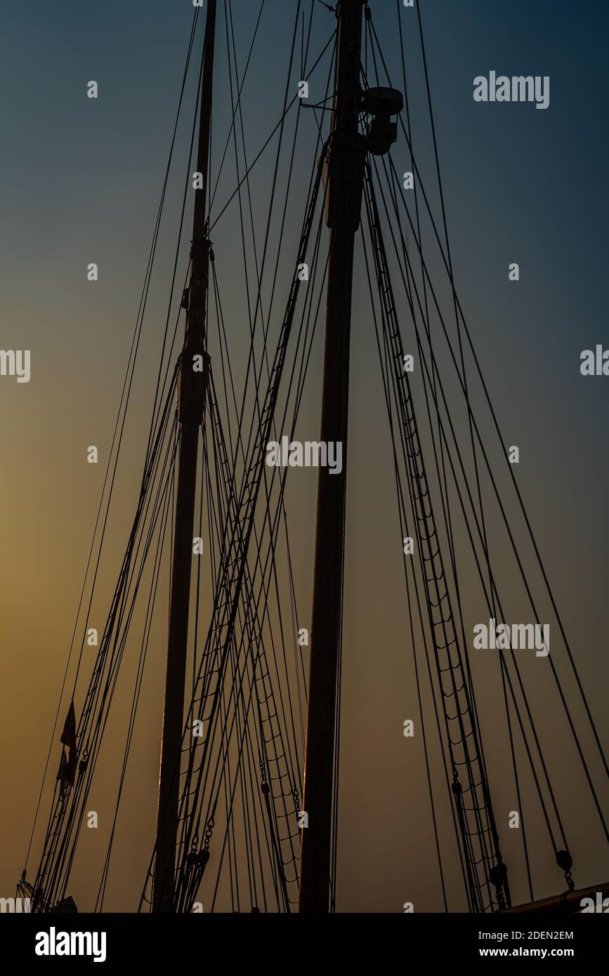 Mast and rigging of an old wooden tall ship, silhouette against the morning light and mist. High quality photo Stock Photo
