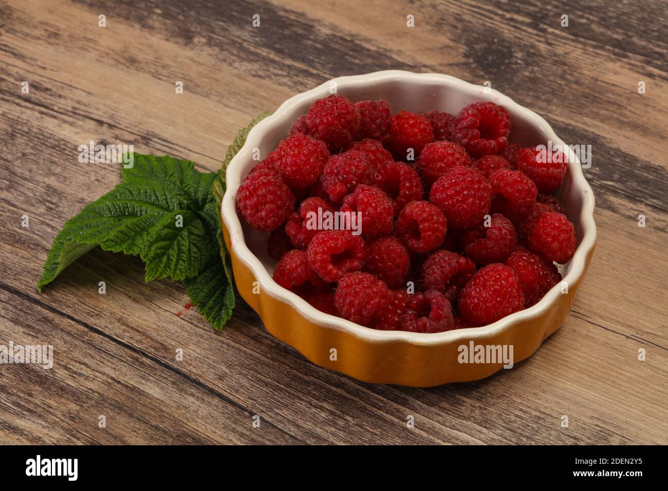 Red bright ripe sweet raspberry with leaf Stock Photo - Alamy