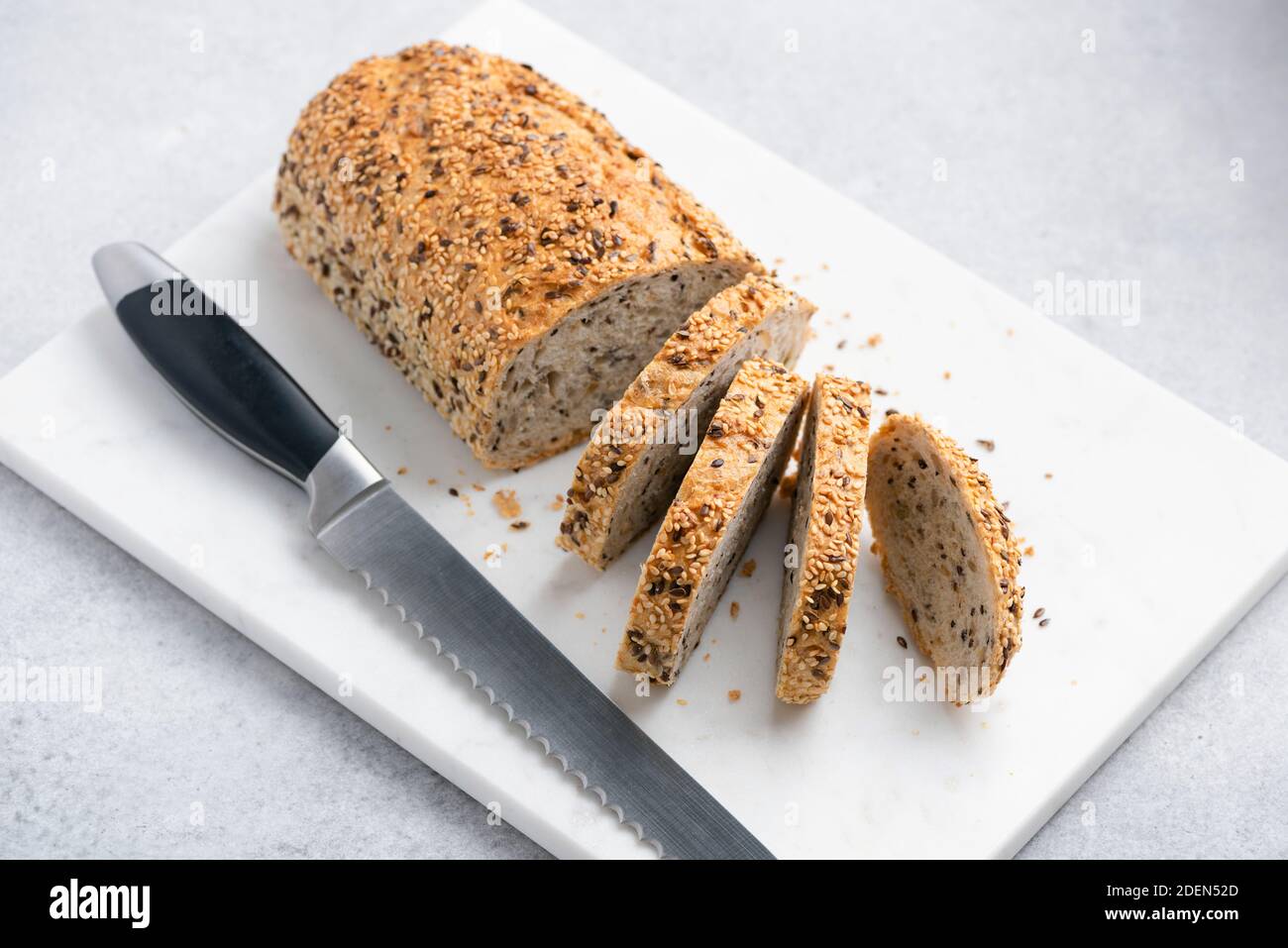 Sliced whole grain bread. Bread with seeds, multigrain bread on marble board Stock Photo