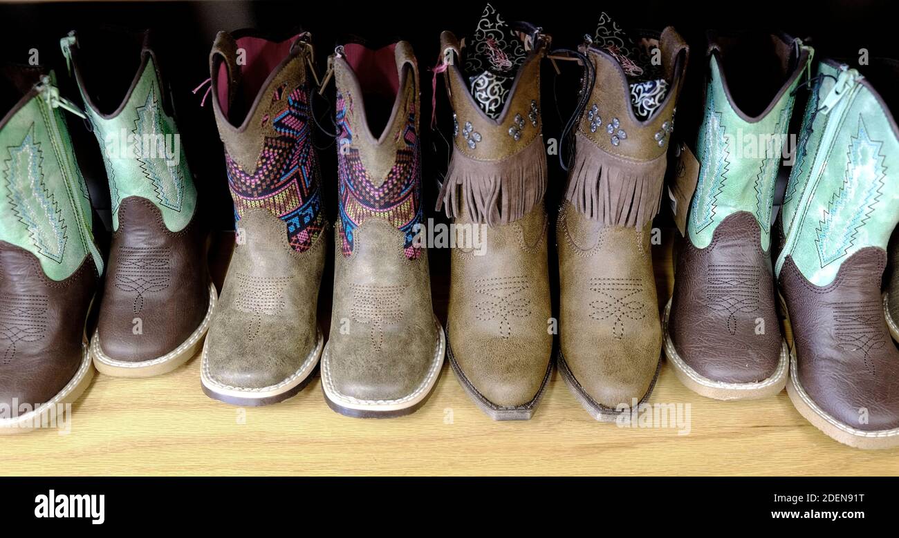 Colorful cowboy boots on shelf for fashion shoes Stock Photo Alamy