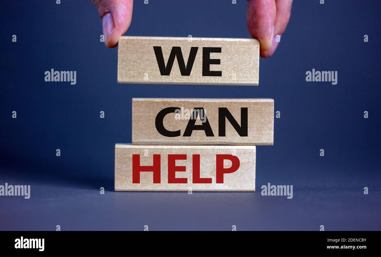 We Help Symbol We can help symbol. Male hand placing a block on top of a blocks tower ...