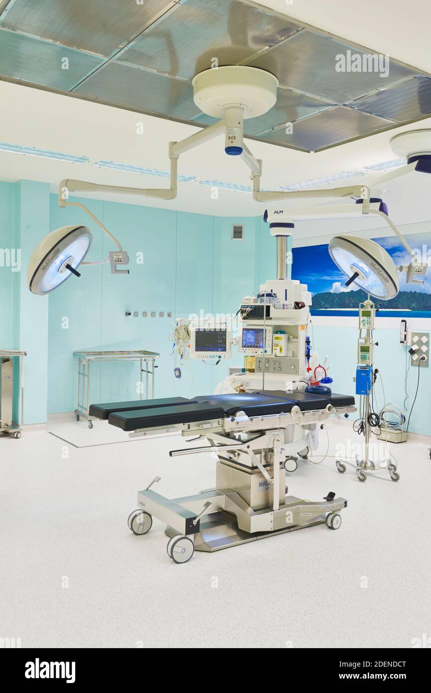 Hospital operating room, with overhead surgical lights, and may have