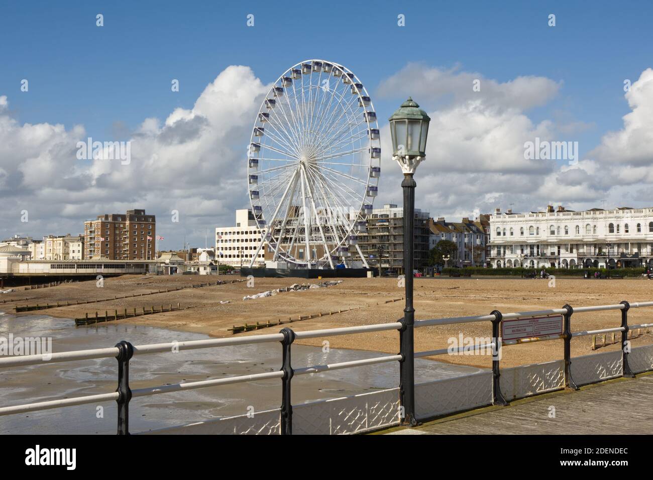 Seafront and beach at Worthing, West Sussex, England. With Ferris wheel viewed from pier. Stock Photo