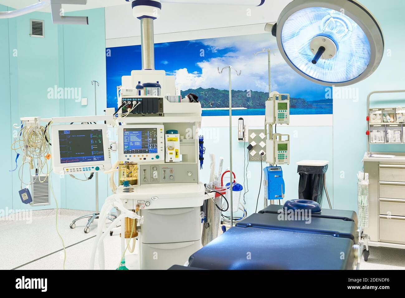Hospital operating room, with overhead surgical lights, and may have viewing screens and