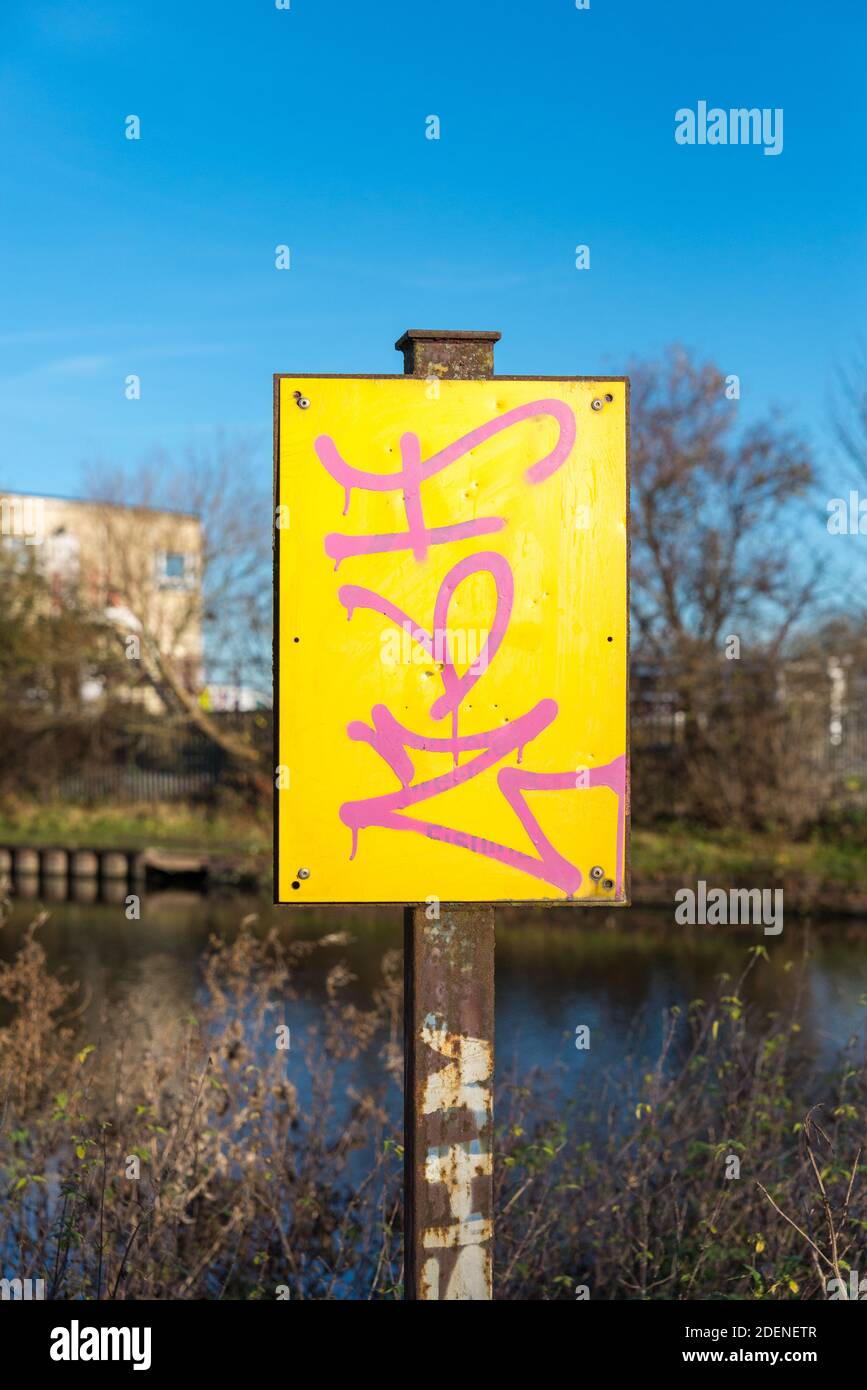 Sign defaced in pink and yellow by Titford Pool in Oldbury,West Midlands which was constructed to feed the Old Main Line Birmingham Canal Stock Photo