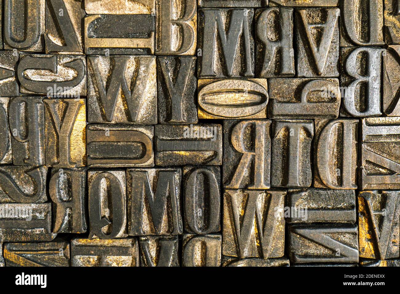 Old wooden letterpress used in a printing press to create reliefs on paper using ink. Jumbled antique letters. Alphabet background. Stock Photo