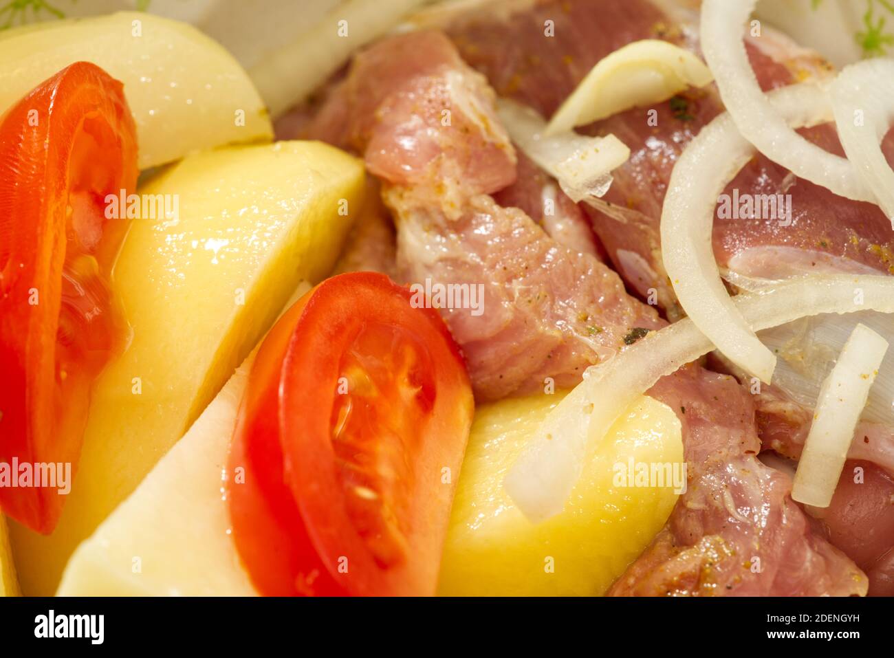 pork meat, potatoes, tomatoes and onions, ready to bake Stock Photo
