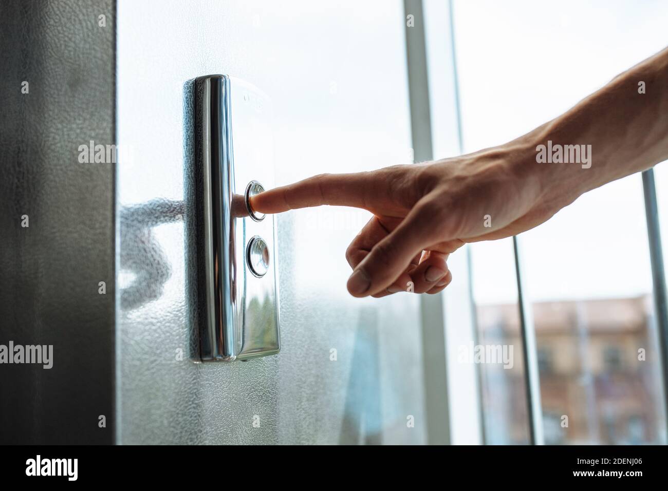The thumb presses the Elevator button, a hand reaching for the button, the girl waiting for Elevator, push button start, isolated Stock Photo