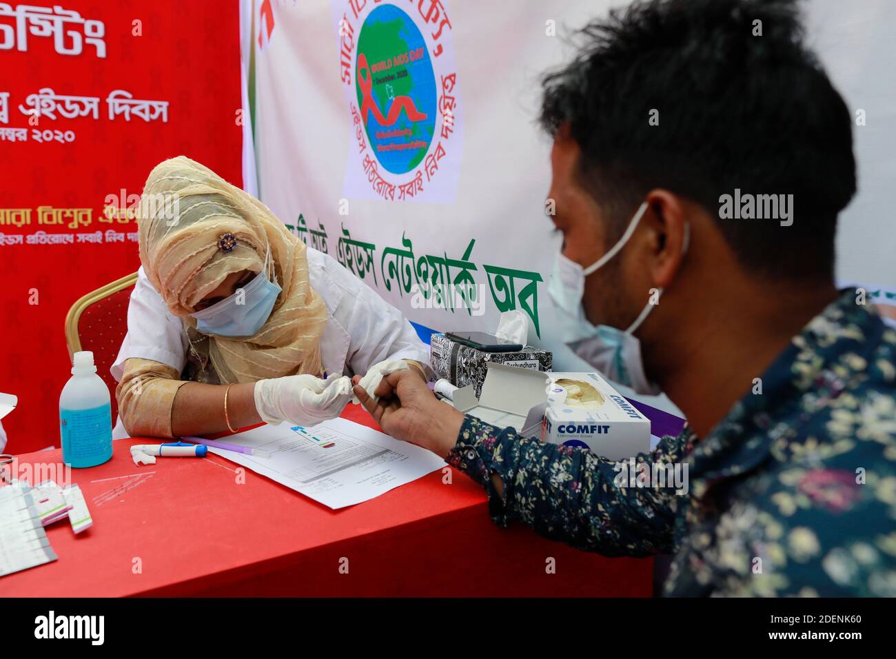 Dhaka, Bangladesh. 1st Dec, 2020. A Bangladeshi health worker collects a blood sample for HIV test during World AIDS Day, in Dhaka, Bangladesh, December 1, 2020. World AIDS Day, designated on 1 December every year since 1988, is an international day dedicated to raising awareness of the AIDS pandemic caused by the spread of HIV infection and mourning those who have died of the disease. Credit: Suvra Kanti Das/ZUMA Wire/Alamy Live News Stock Photo