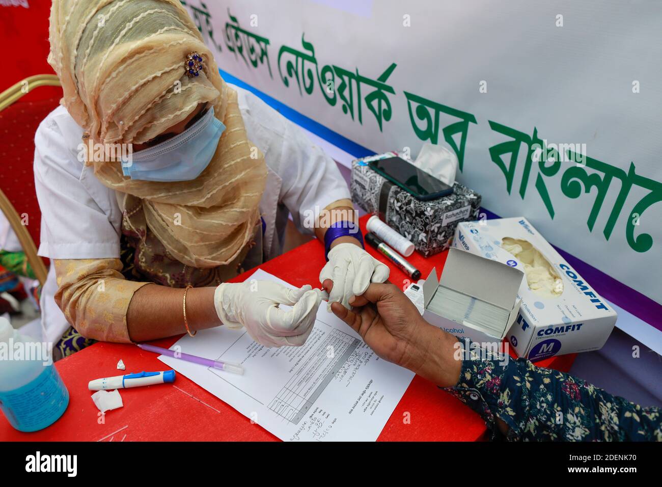 Dhaka, Bangladesh. 1st Dec, 2020. A Bangladeshi health worker collects a blood sample for HIV test during World AIDS Day, in Dhaka, Bangladesh, December 1, 2020. World AIDS Day, designated on 1 December every year since 1988, is an international day dedicated to raising awareness of the AIDS pandemic caused by the spread of HIV infection and mourning those who have died of the disease. Credit: Suvra Kanti Das/ZUMA Wire/Alamy Live News Stock Photo