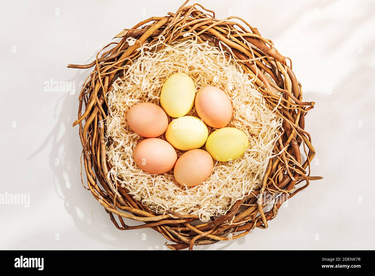 Rural Easter composition with colorful eggs in nest Stock Photo