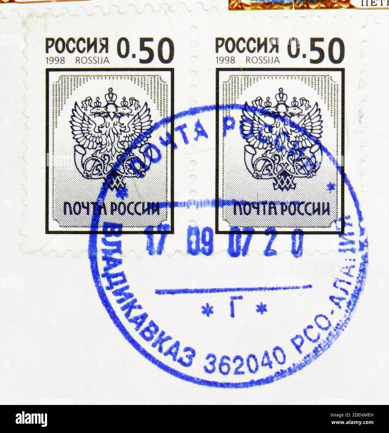 MOSCOW, RUSSIA - MAY 17, 2020: Two postage stamp printed in Russia with stamp of Vladikavkaz city shows Russian Post Emblem, 3rd Definitive Issue of R Stock Photo