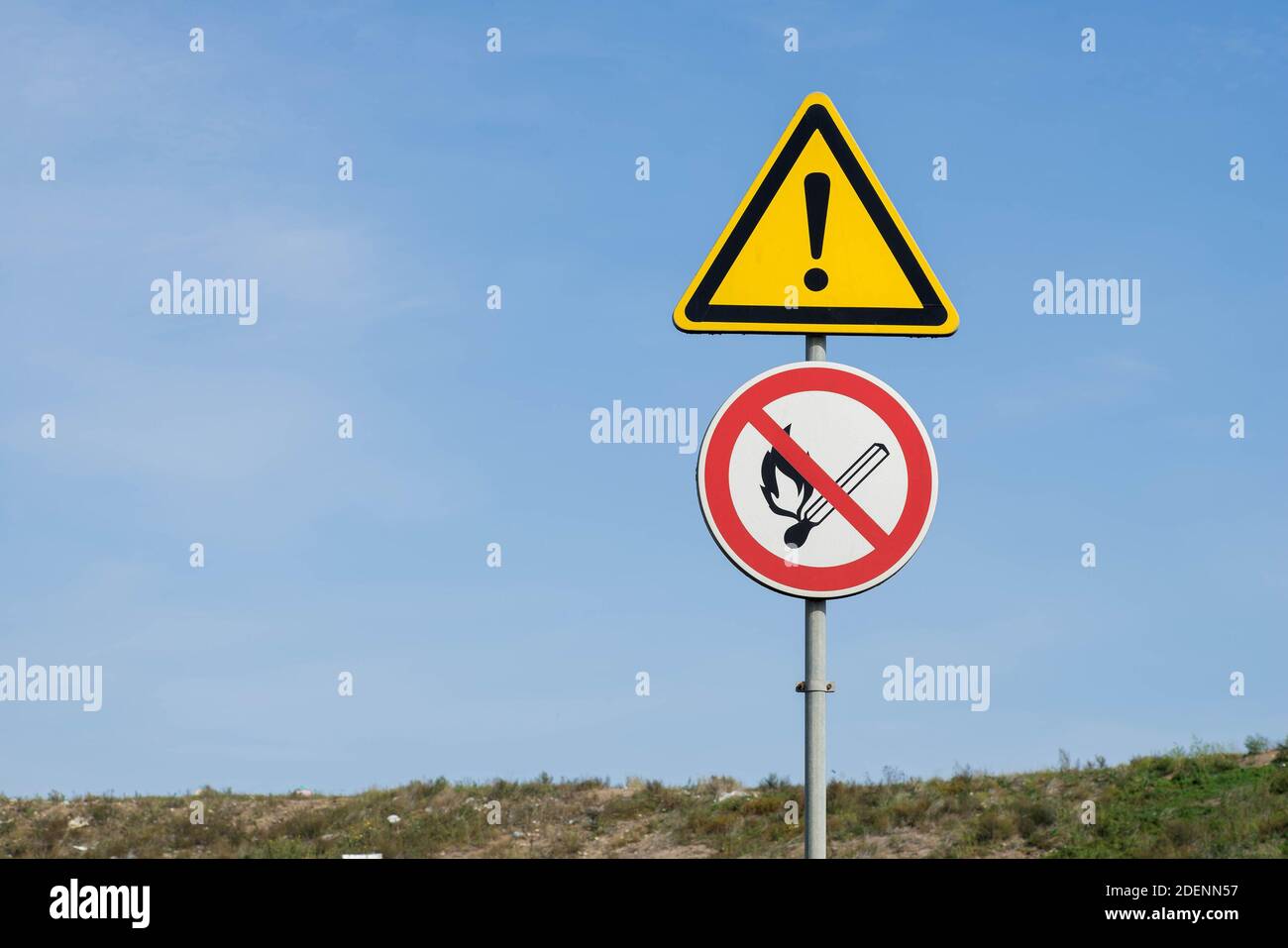 Closeup of yellow warning triangle sign with exclamation mark. Fire