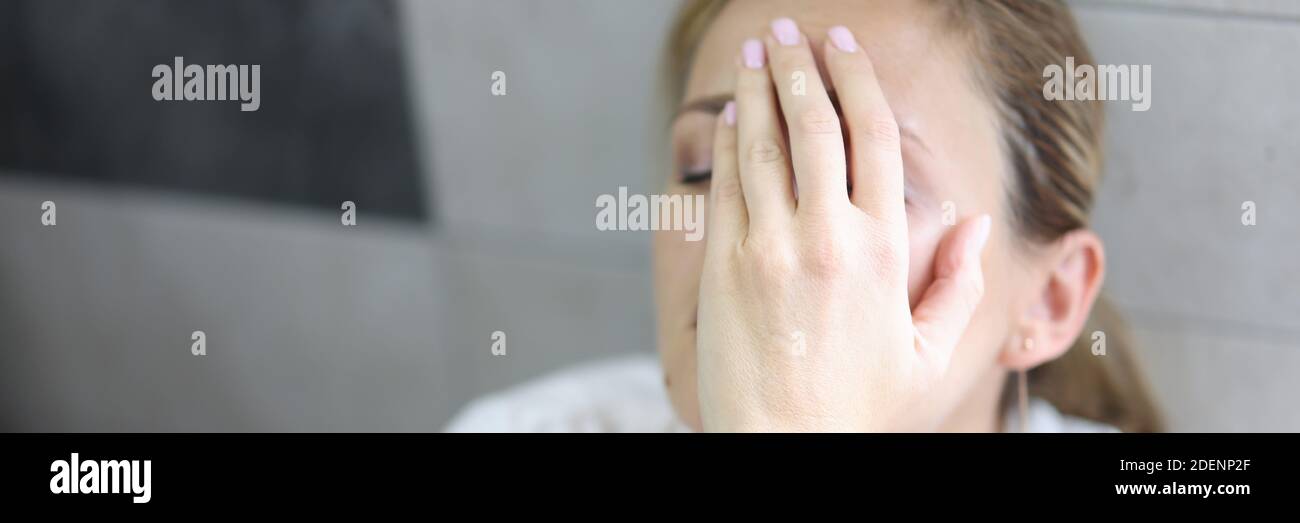 Woman in depression sits with closed eyes Stock Photo