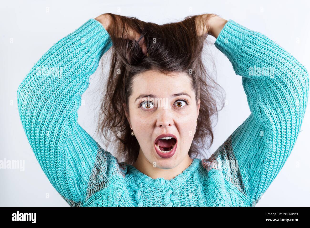 Popeyed girl in shok with open mouth and standing up hair, on a white