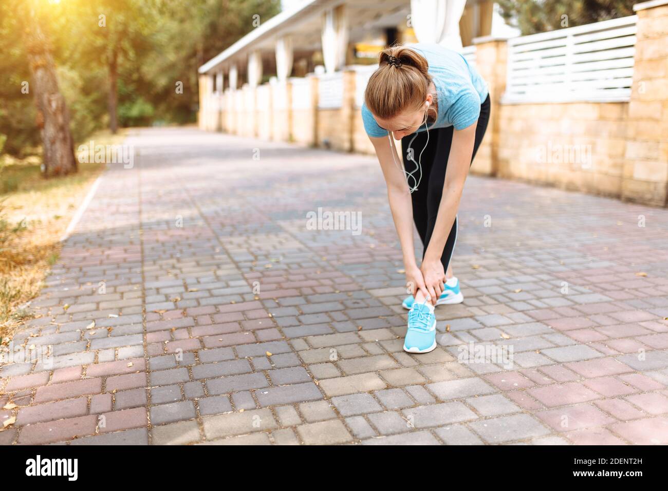 Pain in the leg of the girl after a sports run, morning training Stock