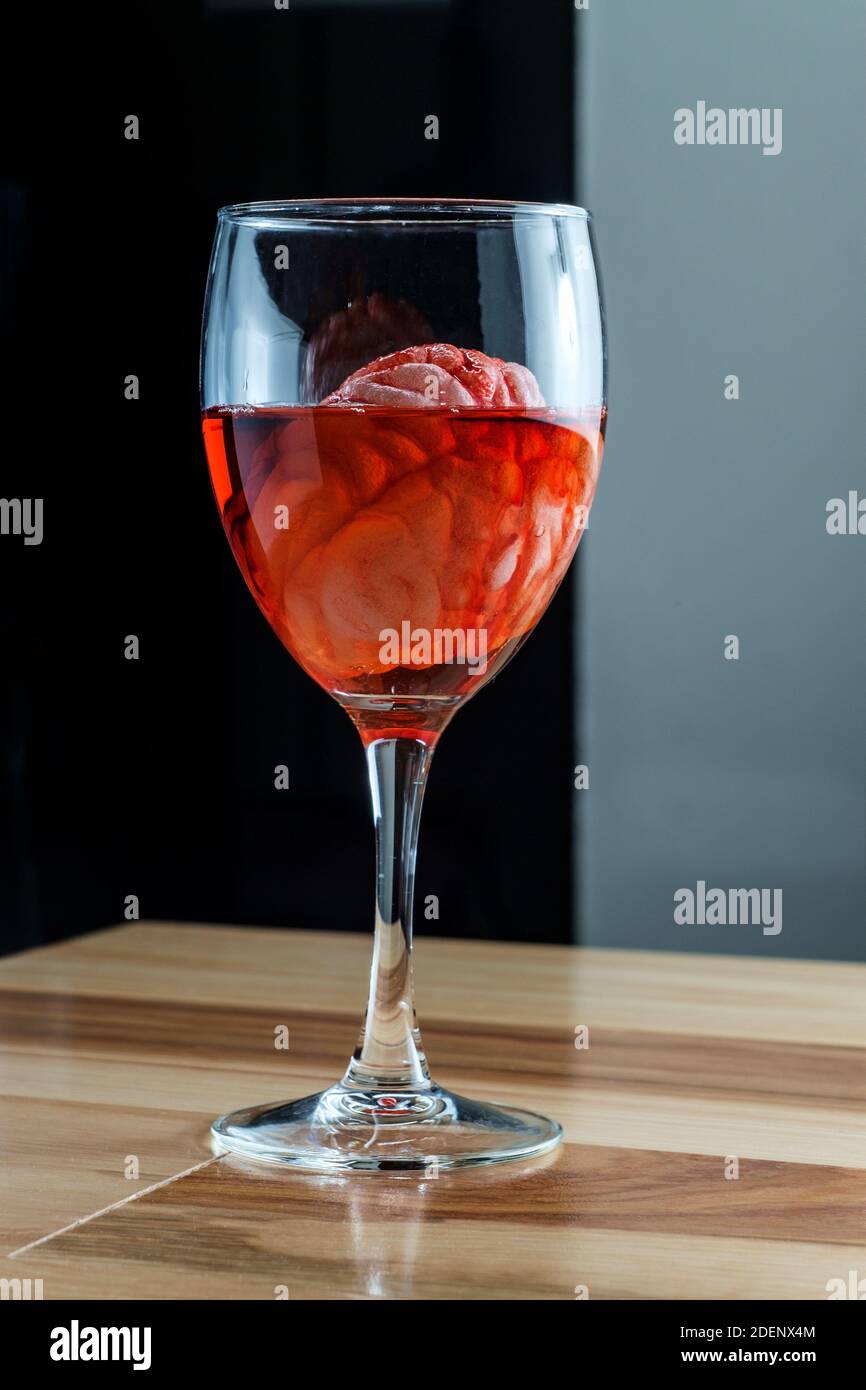 Human brain in red wine glass soaking for alcoholism addiction concept