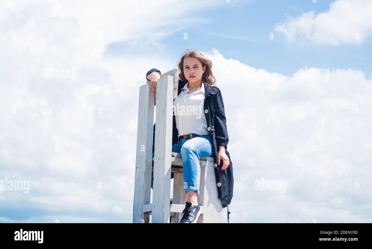 cute kid sit on wooden chair outdoor, rest Stock Photo Alamy