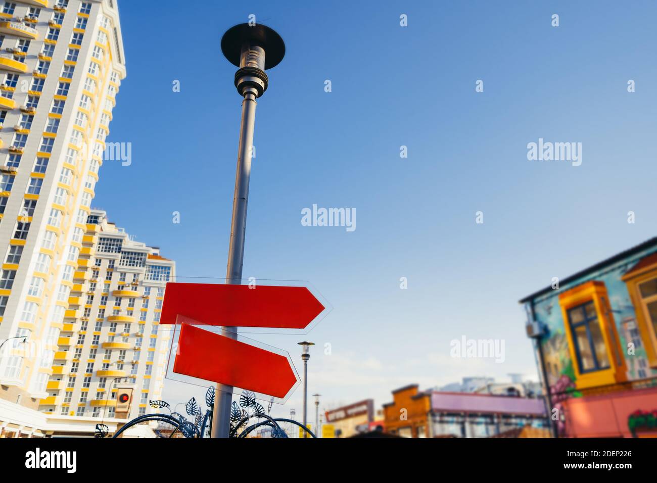 Blank street sign against city. Empty space for text. Road sign, red street sign Stock Photo