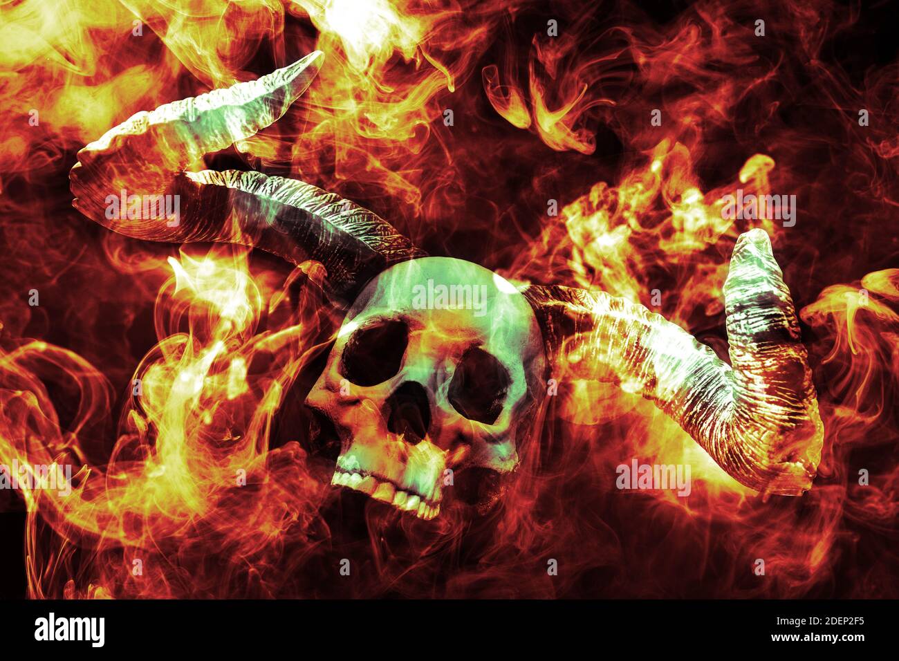 Scary demon Halloween skeleton skull burning in fire Stock Photo - Alamy
