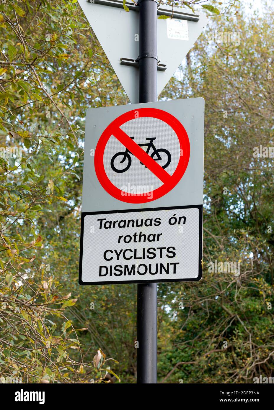 Cyclists dismount signpost park rules in English and Gaelic in ...